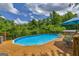 Private in-ground pool with a wooden deck, ideal for summer fun and outdoor relaxation at 684 Doe Lane Ln, Loganville, GA 30052