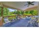 Relaxing porch with outdoor furniture, a ceiling fan, and views of the lush greenery at 684 Doe Lane Ln, Loganville, GA 30052