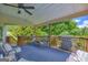 Inviting porch featuring a ceiling fan and relaxing seating overlooking the wooded backyard at 684 Doe Lane Ln, Loganville, GA 30052