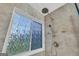 Shower with window and multiple shower heads with tiled surround at 684 Doe Lane Ln, Loganville, GA 30052