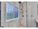 Tiled shower features rain head, sprayer, and textured glass window at 684 Doe Lane Ln, Loganville, GA 30052