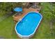 Above-ground pool with a wooden deck, lounge chairs, and umbrella at 684 Doe Lane Ln, Loganville, GA 30052