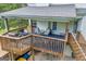 Shot of an outdoor upper deck with multiple seating areas and a grill at 684 Doe Lane Ln, Loganville, GA 30052