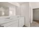 Bright bathroom showcasing a double vanity with marble countertop and a large mirror at 11899 Aukerman Way, Hampton, GA 30228