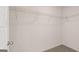 A walk-in closet features carpeted flooring and ample storage racks at 11899 Aukerman Way, Hampton, GA 30228