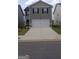 Charming two-story home featuring a two-car garage and a well-manicured front lawn at 11899 Aukerman Way, Hampton, GA 30228