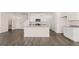 Open-concept kitchen featuring a central island with seating and modern stainless steel appliances at 11899 Aukerman Way, Hampton, GA 30228