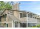 A close-up view of a condo shows neutral siding, a screened porch, and visible unit number for easy identification at 1102 Wynnes Ridge Cir, Marietta, GA 30067