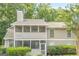 Exterior facade of a multi-unit residence showcasing neutral siding, screened porches, and clearly marked unit numbers at 1102 Wynnes Ridge Cir, Marietta, GA 30067