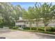 Exterior of building shows well-kept landscaping, screened-in porches, and convenient parking in a serene, tree-lined setting at 1102 Wynnes Ridge Cir, Marietta, GA 30067