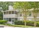 Exterior facade of residence shows neutral siding, screened porches, and clearly marked unit numbers with mature trees at 1102 Wynnes Ridge Cir, Marietta, GA 30067