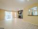Spacious living room featuring light-colored floors, a fireplace, a sliding glass door to a balcony, and a breakfast bar at 1102 Wynnes Ridge Cir, Marietta, GA 30067