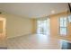 Bright living room featuring light-colored floors, sliding glass doors to a balcony, and a window letting in natural light at 1102 Wynnes Ridge Cir, Marietta, GA 30067