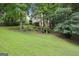 Well-manicured backyard with lush green lawn and mature trees at 1285 Willow Park Way, Cumming, GA 30041