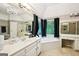 Luxurious bathroom featuring a soaking tub, double vanity, and a chandelier at 1285 Willow Park Way, Cumming, GA 30041