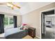 Bright bedroom featuring a ceiling fan, large window, and neutral-toned walls at 1285 Willow Park Way, Cumming, GA 30041