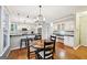 Bright dining area features wood floors, an eating area, white cabinets, and a kitchen view at 1285 Willow Park Way, Cumming, GA 30041