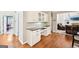 Bright dining area with hardwood floors, white cabinetry and black countertops at 1285 Willow Park Way, Cumming, GA 30041