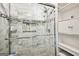 Tiled shower with glass doors and built-in shelving, showcasing modern bathroom design at 1285 Willow Park Way, Cumming, GA 30041