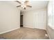 The bedroom features carpet floors, a ceiling fan, and a closet with sliding doors at 6194 Golden Meadow Court Ct, Riverdale, GA 30296