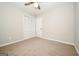 Bedroom with neutral walls, carpeting, ceiling fan and louvered closet doors at 6194 Golden Meadow Court Ct, Riverdale, GA 30296
