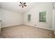 Bright bedroom with a vaulted ceiling, neutral carpet, and two sunlit windows at 6194 Golden Meadow Court Ct, Riverdale, GA 30296