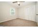 Bedroom with neutral walls, carpeting, ceiling fan and window at 6194 Golden Meadow Court Ct, Riverdale, GA 30296