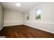 Versatile living room space with sleek flooring and natural light from two windows at 6194 Golden Meadow Court Ct, Riverdale, GA 30296