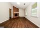 Inviting living room with striking brick fireplace and rich, dark wood-look flooring at 6194 Golden Meadow Court Ct, Riverdale, GA 30296