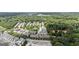 Overhead view of a townhome community surrounded by lush greenery, showcasing the neighborhood's layout at 1004 Bayrose Cir, East Point, GA 30344