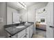 Bathroom featuring granite countertops, white cabinets, and access to the main bedroom at 1004 Bayrose Cir, East Point, GA 30344
