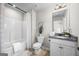 Well-lit bathroom featuring a shower-tub combo, a vanity with a granite countertop and modern fixtures at 1004 Bayrose Cir, East Point, GA 30344