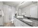Clean bathroom featuring a granite countertop and white shower with glass doors at 1004 Bayrose Cir, East Point, GA 30344