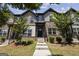 Inviting two-story townhome featuring a brick facade, landscaped yard and welcoming front entrance at 1004 Bayrose Cir, East Point, GA 30344