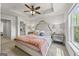 Cozy main bedroom boasts a decorative headboard, tray ceiling, and bright windows at 1004 Bayrose Cir, East Point, GA 30344