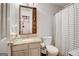 Clean bathroom featuring a vanity with a granite countertop, a toilet, and a shower with patterned curtains at 1753 Liberty Pkwy, Atlanta, GA 30318