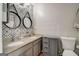 Stylish bathroom featuring a double vanity, granite countertop, and decorative wallpaper at 1753 Liberty Pkwy, Atlanta, GA 30318