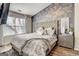 Stylish bedroom featuring a tufted headboard, patterned wallpaper, and natural light from the window at 1753 Liberty Pkwy, Atlanta, GA 30318
