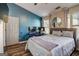 Comfortable bedroom with a hardwood floor, complemented by a blue accent wall and natural lighting at 1753 Liberty Pkwy, Atlanta, GA 30318