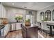 Well-lit kitchen featuring stainless steel appliances, a black island, white cabinets, and a dining area at 1753 Liberty Pkwy, Atlanta, GA 30318