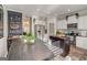 A well-lit kitchen featuring stainless steel appliances, a black island, white cabinets, and a dining area at 1753 Liberty Pkwy, Atlanta, GA 30318