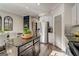 Well-lit kitchen featuring stainless steel appliances, a black island, white cabinets, and a dining area at 1753 Liberty Pkwy, Atlanta, GA 30318