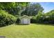Tranquil backyard featuring a storage shed, lush lawn, and privacy hedges at 2855 Briarlake Ne Rd, Atlanta, GA 30345