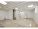 Spacious basement area with mixed flooring, stairs, and a white refrigerator at 2855 Briarlake Ne Rd, Atlanta, GA 30345