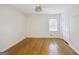 Minimalist bedroom with natural light, hardwood floors, and a closet with white doors at 2855 Briarlake Ne Rd, Atlanta, GA 30345