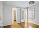 Neutral bedroom featuring a unique sliding mirror door, hardwood floors and natural light at 2855 Briarlake Ne Rd, Atlanta, GA 30345