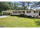 Charming single-story home featuring a white brick facade, covered carport, and a well-maintained lawn at 2855 Briarlake Ne Rd, Atlanta, GA 30345