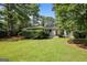 Charming home featuring a beautifully landscaped yard with mature trees and manicured bushes at 2855 Briarlake Ne Rd, Atlanta, GA 30345
