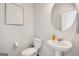 Bathroom with a toilet, sink with mirror, and artistic decor at 179 Stanchion Dr, Union City, GA 30291