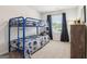 Bright bedroom with a blue bunk bed, ample natural light, and comfortable carpet at 179 Stanchion Dr, Union City, GA 30291